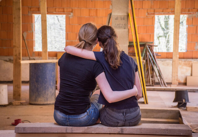 Girlfriends looking at their home renovations mid-construction