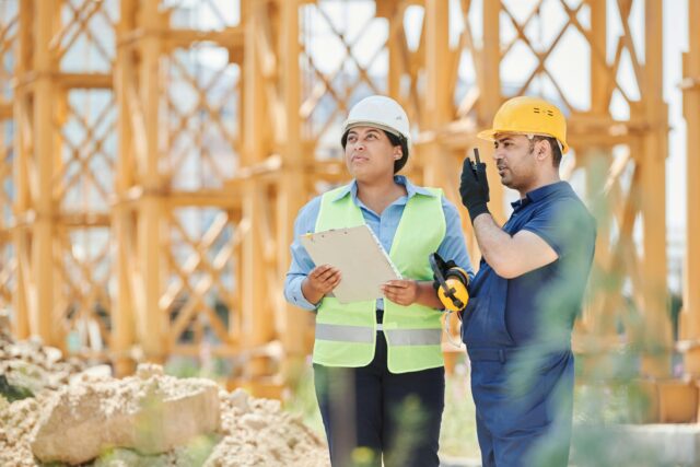 Construction workers with a clipboard